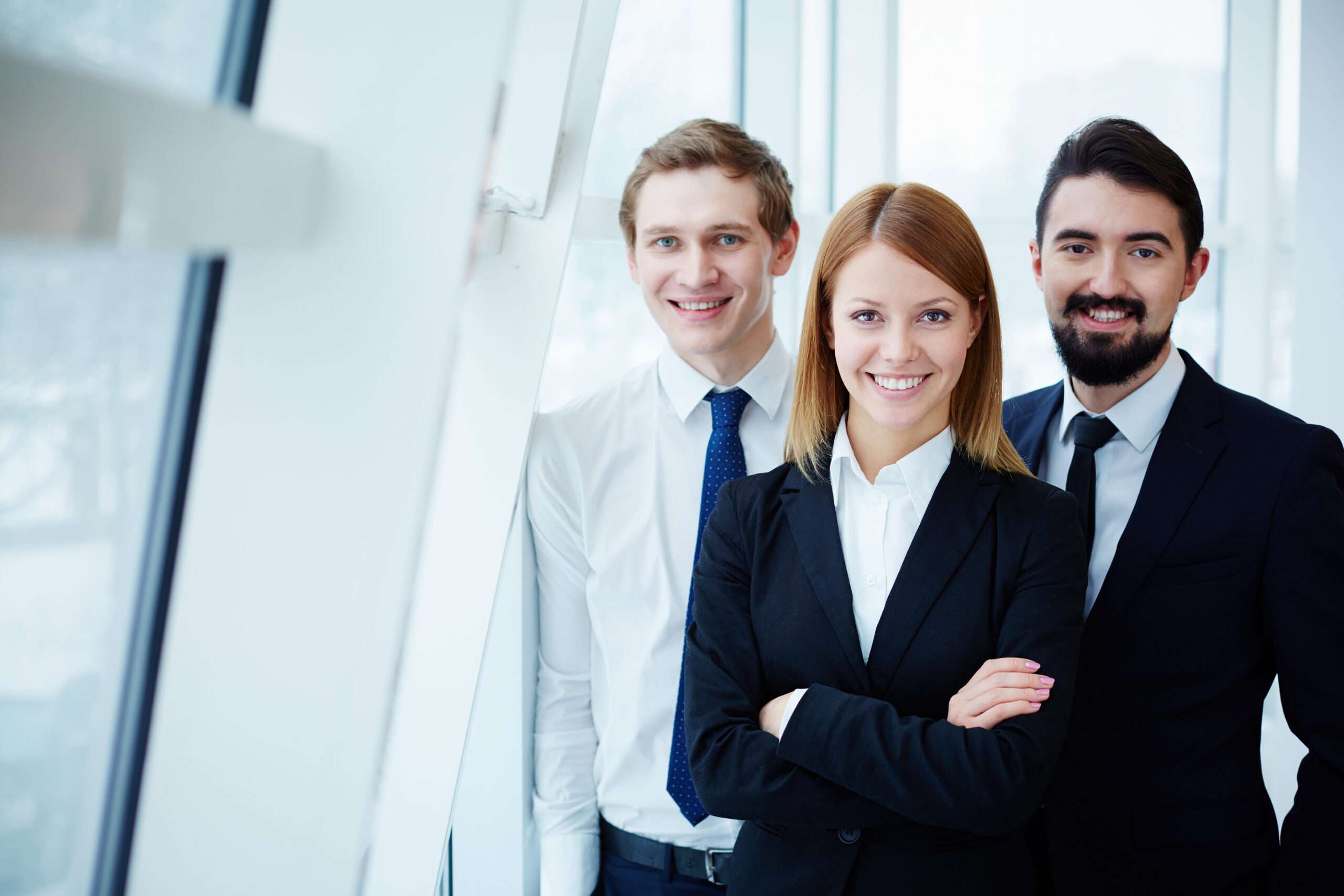 Three successful business partners looking at camera with smiles